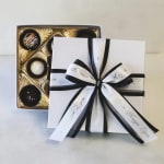 Box of assorted chocolates tied with black and white ribbon