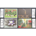 Four artwork prints are arranged on a dark surface with numbered cards beside them.