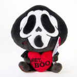 Plush Ghostface doll holding a red heart with "HEY, BOO" text