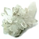 Cluster of clear quartz crystals on a white background