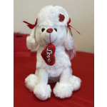 White plush dog holding a red heart that says Love
