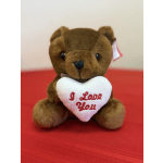 Brown teddy bear holding a white heart with "I Love You" text