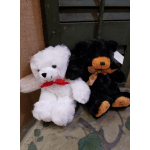 Two plush teddy bears, one white and one black, with ribbons