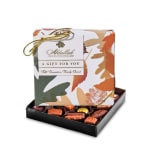 Box of assorted chocolates with a patterned gift lid and gold ribbon