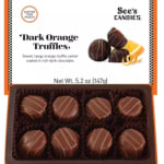 Box of dark orange truffles in a chocolate tray