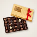 Godiva chocolate assortment in a gold gift box with a red ribbon