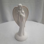 White angel figurine with folded hands and gold-trimmed wings