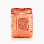 Orange glass candle jar with a labeled lid