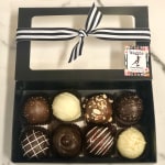 Box of assorted chocolate truffles tied with a black-and-white ribbon