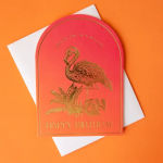 Pink birthday card with a gold flamingo illustration on an orange background
