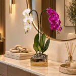 Potted orchid arrangement with white and magenta blooms in a gold planter