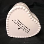 White heart-shaped ceramic keepsake with printed memorial text