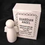 White guardian angel figurine beside a matching gift box