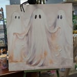Canvas with three cartoon ghosts on an easel