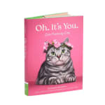 Pink book with a cat illustration on the cover