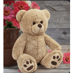 Teddy bear beside a vase of pink flowers