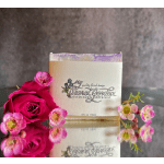 Pink roses and small pink blossoms arranged around a branded box