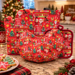 Christmas-themed red oven mitts and pot holders on a kitchen counter