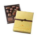 Box of assorted chocolates with a gold lid and ribbon