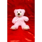 Pink teddy bear with a white ribbon on a red satin background