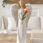 Angel figurine holding an orange flower