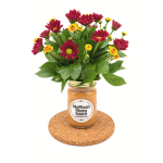 Red and yellow flowers in a jar vase on a cork coaster