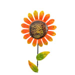 Metal sunflower decoration with orange petals and green leaves on a stem