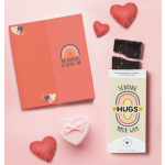 Chocolate bar and heart-shaped gift boxes on a pink background