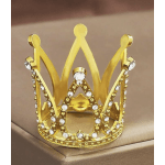 Gold crown with clear rhinestones on a beige surface