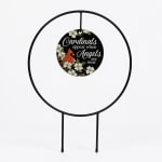 Black metal memorial sign with a cardinal and flowers