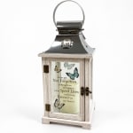 Decorative memorial lantern with butterfly design and a candle inside