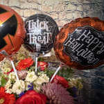 Halloween bouquet with balloons reading Trick or Treat and Happy Halloween