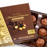 Box of milk chocolate macadamia nut candies in a tray