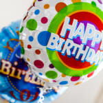 Birthday balloons with colorful polka dots and rainbow graphics