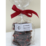 Bag of chocolate-dipped pretzels tied with a red ribbon