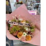 Pink bouquet with roses, lilies, and mums wrapped in pink paper