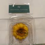 Packaged yellow chocolate candy in a clear plastic container