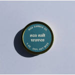 Round candle tin labeled "sea salt waves"