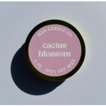 Round candle tin with a pink label reading cactus blossom