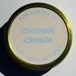 Round tin container labeled coconut clouds