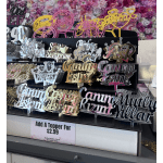 Display of colorful acrylic birthday cake toppers on a shelf