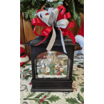 Black lantern with a Christmas village scene and red-silver ribbon bow