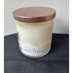 A lavender and sweet lemon scented candle in a glass jar with a rose-gold lid