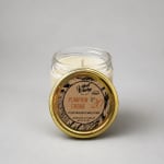 Jar candle with a gold lid labeled Pumpkin Creme