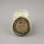 A jar candle with a gold lid labeled Light Linen.