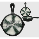 Three cast-iron skillet candles with white wax and green accents