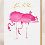 Pink flamingo illustration with the words "Love Is Us..." above it