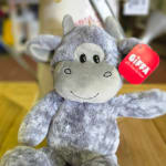 Gray plush monkey toy with a red gift tag