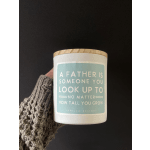 A vanilla-scented candle in a white jar with a wooden lid