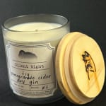 Glass candle jar with a wooden lid and printed label
